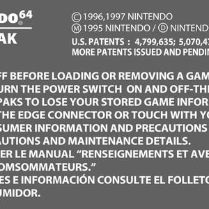 May include: A gray Nintendo 64 Game Pak label with white text. The label includes the Nintendo logo, the text "NINTENDO 64 GAME PAK", and a list of cautions and warnings. The label also includes patent information and the text "MADE IN JAPAN."