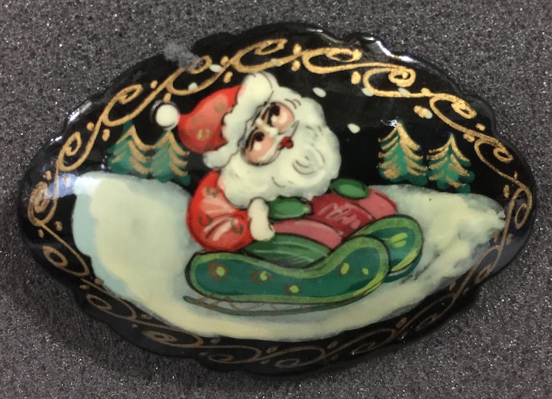Hand Painted Santa riding on a sled Vintage pin hand made in Russia