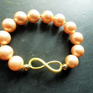 Bracelet, Shell Pearls, Brass, Infinity, salmon-colored, Rocaille Pearls, Statement Jewelry