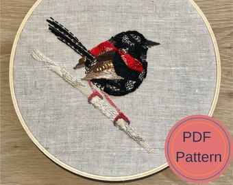 May include: Embroidered artwork of a black and red bird perched on a white branch. The artwork is framed in a round wooden hoop. The text "PDF Pattern" is visible in the lower right corner of the image.