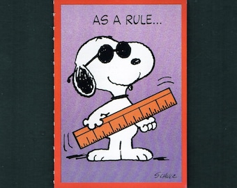 May include: A Snoopy cartoon image on a purple background with the text "AS A RULE...". Snoopy is wearing sunglasses and holding an orange ruler. The image has a red border and the artist's signature, Schulz, is in the bottom right corner.