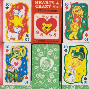 May include: A vintage Hearts & Crazy 8's card game set. The cards feature colorful illustrations of animals, hearts, and stars. The card box is red with white text. The backs of the cards have a green pattern with a monkey face.