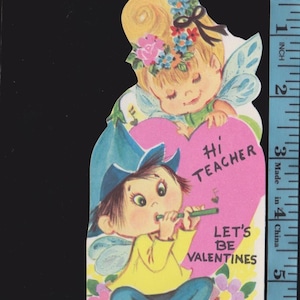 May include: Vintage Valentine's Day card featuring two cartoon children. One child is playing a flute, and the other is holding a pink heart with the words "Hi Teacher." The card is approximately 3 inches tall.