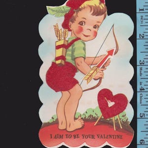 May include: Vintage Valentine's Day card featuring a cartoon cupid with a bow and arrow. The cupid wears a red hat, shorts, and a green shirt. The card includes the text "I AIM TO BE YOUR VALENTINE" and a heart.
