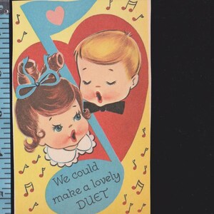 May include: Vintage Valentine's Day card featuring a boy and girl singing, set against a red heart and musical note. The card has a yellow background with musical notes and the text "We could make a lovely DUET."