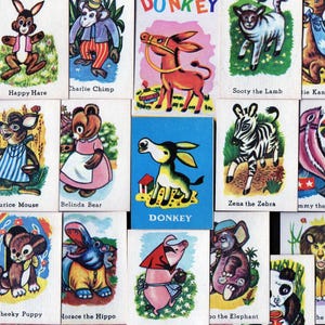 May include: A collection of vintage animal flashcards featuring cartoon illustrations of various animals, including a tiger, donkey, and zebra. Each card has the animal's name printed below the image.