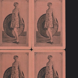 May include: Four vintage playing cards featuring a woman in a floral dress and a large fan. The cards have a sepia tone and are framed with a decorative border. The woman is wearing a hat and shoes.