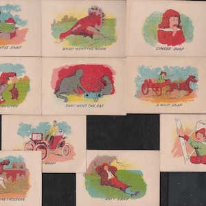May include: A collection of vintage illustrated cards with various scenes and text. The cards feature colorful illustrations and text such as "One Two Three Snap", "Snap Went The Worm", and "Ginger Snap". The cards are likely from a children's game or story.