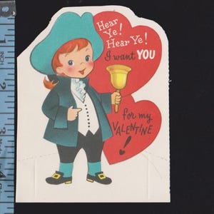 May include: Vintage Valentine's Day card featuring a cartoon illustration of a boy in colonial attire. The boy, with red hair and a teal hat and coat, holds a bell. Red hearts with text that reads "Hear Ye! I want YOU for my VALENTINE!"