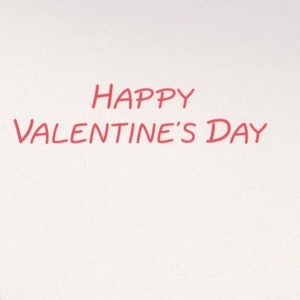 May include: A white background with the red text "HAPPY VALENTINE'S DAY" in a handwritten style. The text is centered and takes up a significant portion of the image, suitable for a Valentine's Day card or message.