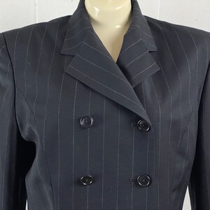 May include: A black pinstripe blazer with a double-breasted closure and four buttons.