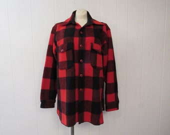 May include: A red and black plaid flannel shirt with long sleeves and a button-up front.