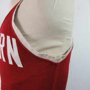 May include: Red basketball jersey with white trim and the word "WESTERN" in white lettering on the front.