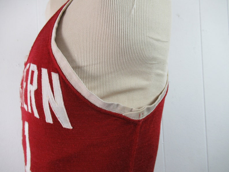 May include: Red basketball jersey with white trim and the word "WESTERN" in white lettering on the front.