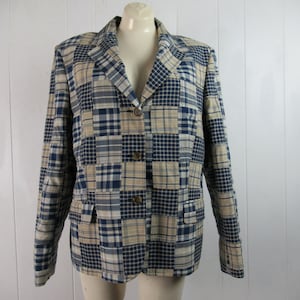 May include: A blue and beige plaid blazer with a button closure. The blazer is made of a patchwork fabric with different sized squares.