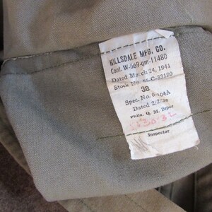 May include: A white tag with black text that reads "HILLSDALE MFG. CO. Cont. W-669-gm-11480 Dated March 24, 1941 Stock No. 56-C-33120 38 Spec. No. 6-104A Dated 2/2/38 Phila. Q. M. Depot 5530-3L Inspector"