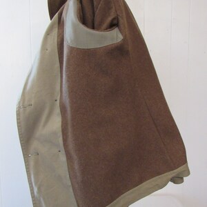May include: A brown wool jacket with a beige lining. The jacket has a single-breasted closure and a patch pocket on the left side.