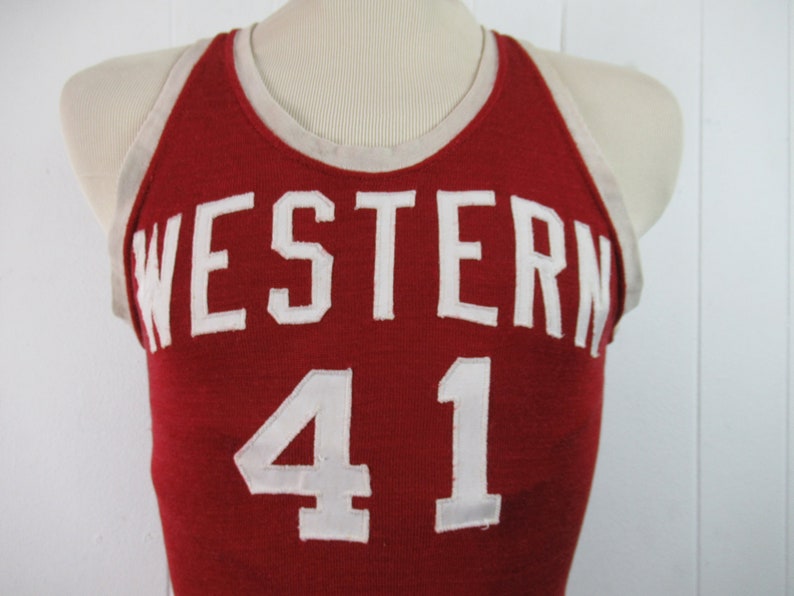 May include: Red basketball jersey with white trim and the word "WESTERN" and the number "41" in white.