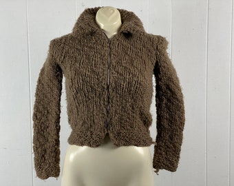 May include: A brown knitted zip-up sweater with a chunky knit texture.