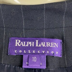 May include: A black and white striped blazer with a purple label that reads "Ralph Lauren Collection" and a size tag that says "10".