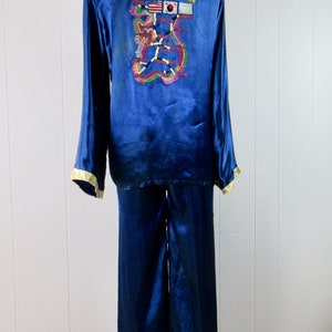 May include: Blue satin pajamas with a map of Korea embroidered on the back. The map includes flags of South Korea, the United States, and the United Nations.