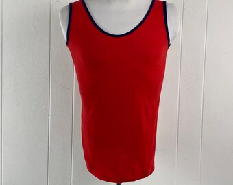 May include: A red sleeveless tank top with a navy blue trim around the neckline.