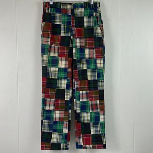 May include: Patchwork plaid trousers in a variety of colours, including red, green, blue, and white.