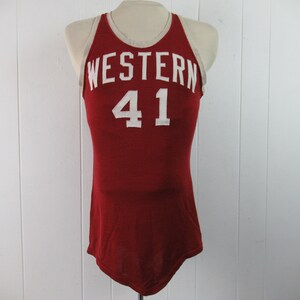May include: A red basketball jersey with white trim and the word "WESTERN" and the number "41" on the front.