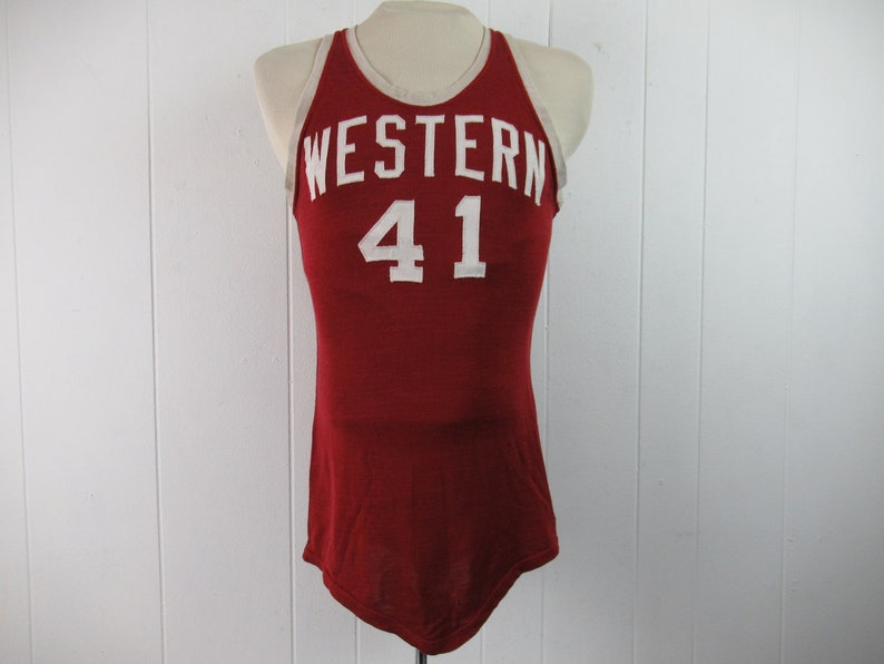 May include: A red basketball jersey with white trim and the word "WESTERN" and the number "41" on the front.