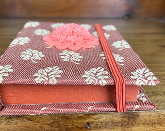 small orange fabric notebook with brooch decoration (ref 54)