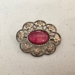 Vintage silver tone floral brooch with pink stone