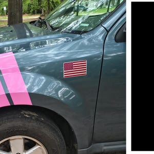 May include: A teal car with pink racing stripes and an American flag sticker. The car's front tire and part of the wheel well are visible. Two black vertical stripes are on the right.