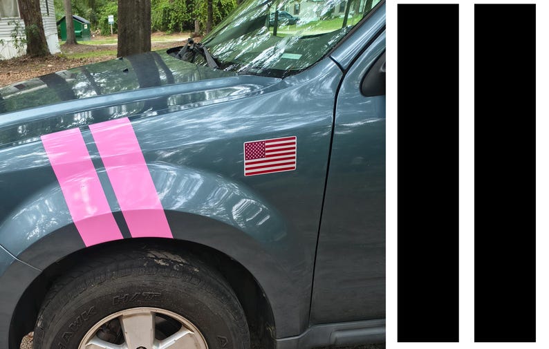 May include: A teal car with pink racing stripes and an American flag sticker. The car's front tire and part of the wheel well are visible. Two black vertical stripes are on the right.