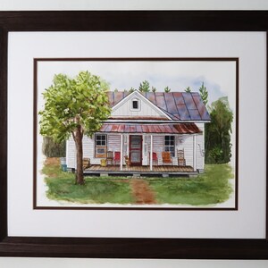 May include: A watercolor painting of a white farmhouse with a rusty metal roof. The house has a front porch with rocking chairs and a large tree in the front yard.