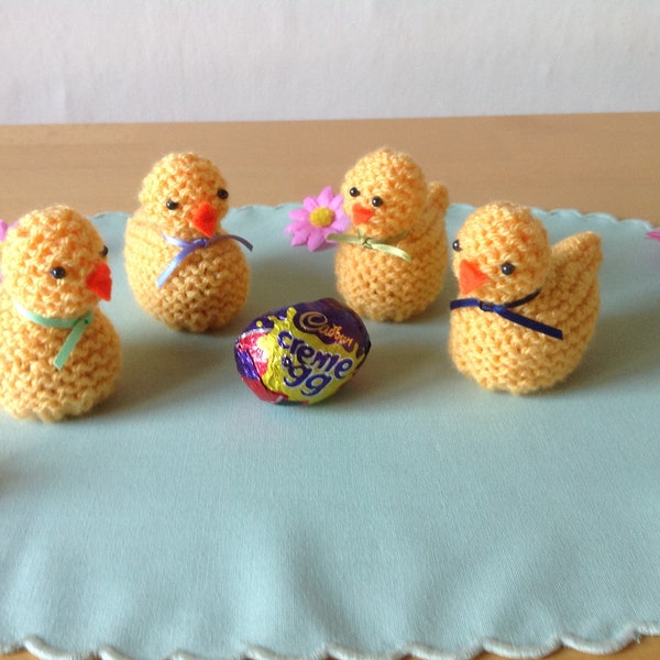 A hand knitted daffodil yellow Easter chick to cover a Cadbury's creme egg or similar.