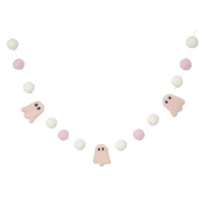 May include: A pink and white felt garland with pink ghost cutouts. The garland is strung with white and pink pom poms.