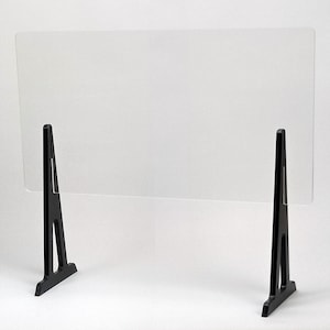 May include: A clear acrylic sneeze guard with two black plastic A-frame stands. The sneeze guard is designed to protect people from coughs and sneezes.