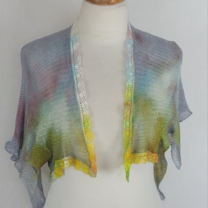 May include: A gray, yellow, and blue tie-dye knitted shawl with a white lace trim.