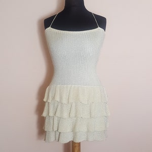 Mini dress with straps, Mini dress with shiny metallic thread, Mini dress in ekri color. Mini dress with ruffles