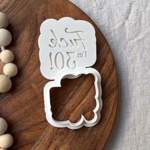 Plastic cookie cutter and fondant stamp with a custom design saying 'Fuck I'm 30!', made of durable plastic and shown on a countertop.