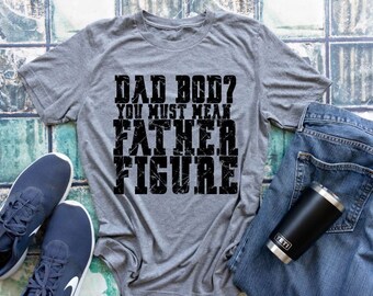 May include: A gray t-shirt with a distressed black graphic that reads "Dad Bod? You must mean Father Figure."