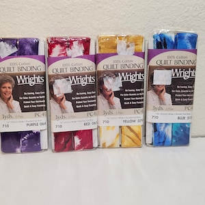 May include: Four packages of 100% cotton quilt binding in purple, red, yellow, and blue. Each package contains 3 yards of 22mm wide double fold bias binding. The packages are labeled "Wrights Quilt Binding" and include the color and number of the binding.