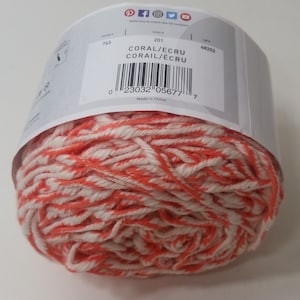 May include: A ball of coral and ecru yarn. The label reads "CORAL/ECRU CORAIL/&Eacute;CRU" and has a barcode. The label also says "Made in China".