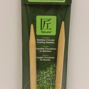 May include: A pair of 29-inch (74 cm) bamboo circular knitting needles in a plastic package. The needles are size 15 (10.0 mm) and are labeled "Takumi Premium Bamboo Circular Knitting Needles".