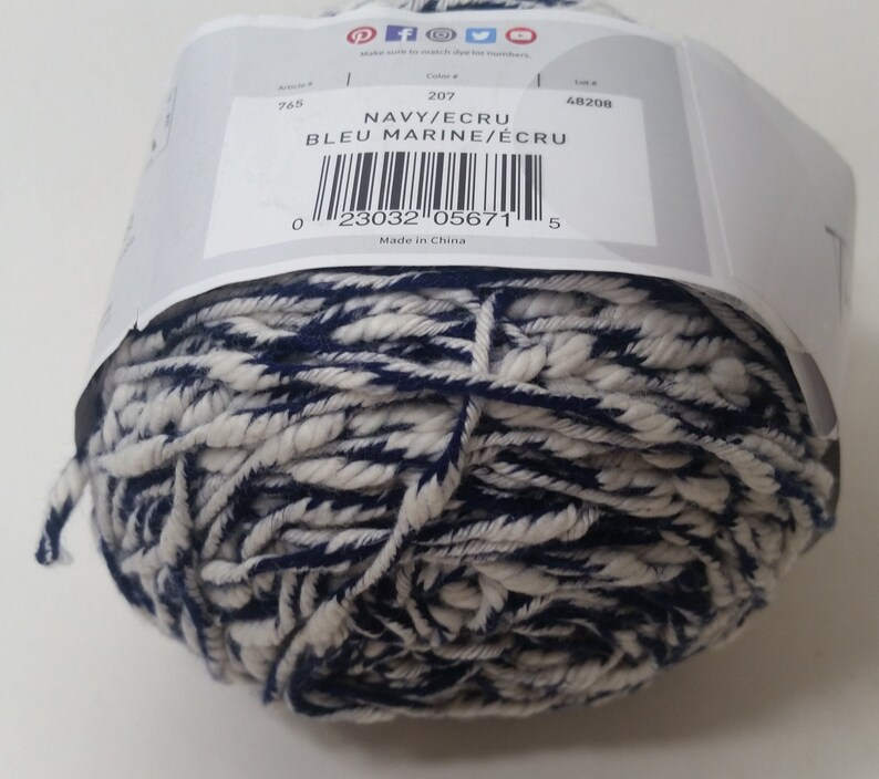 May include: A ball of navy blue and ecru yarn. The label reads "NAVY/ECRU BLEU MARINE/&Eacute;CRU" and has a barcode. The label also says "Made in China".