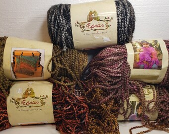 May include: A selection of yarn skeins in shades of brown, green, black, and pink. Each skein has a label with the text "Epais, A Colorfusion Yarn" and an image of a bird. The yarn is suitable for knitting and crochet projects.