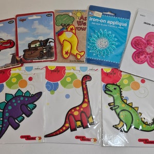 Iron-On Appliques, Dinosaurs, Brown Truck (Mater), Red Car (Lightening McQueen), Airplane, Pink Sequin Flower, Blue Sequin Flower