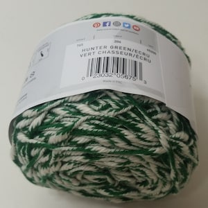 May include: A ball of green and white yarn with the text "HUNTER GREEN/ECRU VERT CHASSEUR/ECRU" and a barcode. The yarn is made in China.