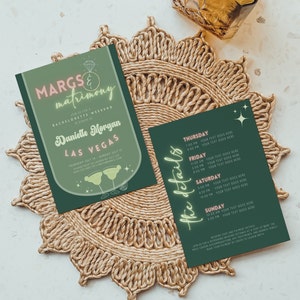 May include: Two dark green bachelorette party invitations with the text "MARGS & matrimony" and "Danielle Morgan Las Vegas". One card lists event details. The cards are on a woven placemat.