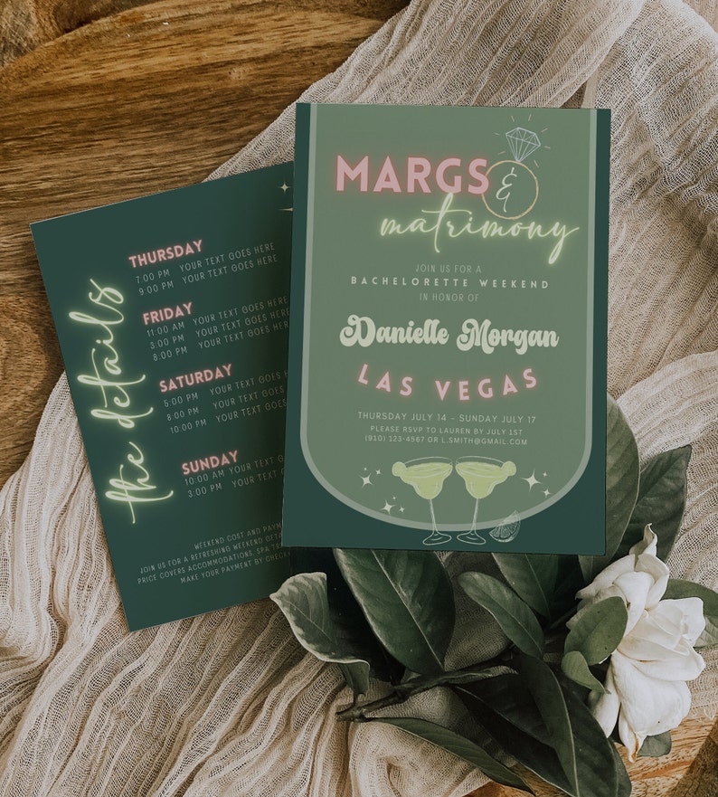 May include: Two dark green invitations with white and pink text. The main invitation reads "Margs & Matrimony" and "Danielle Morgan Las Vegas". The second invitation lists event details. The invitations are surrounded by greenery and a white flower.